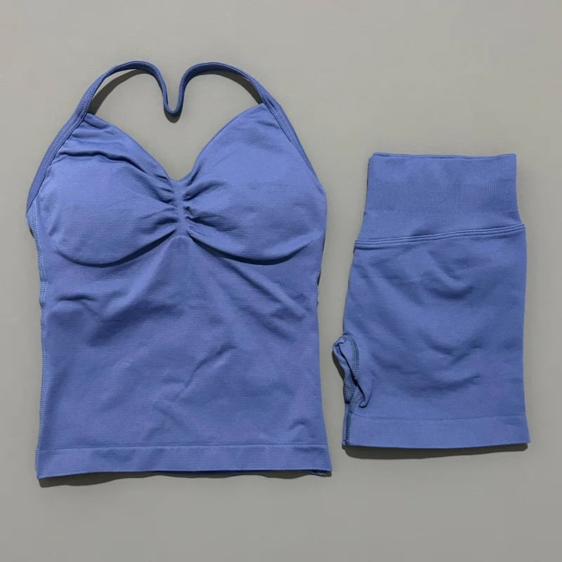 A purple women's seamless fitness set consisting of a cropped top and matching leggings.