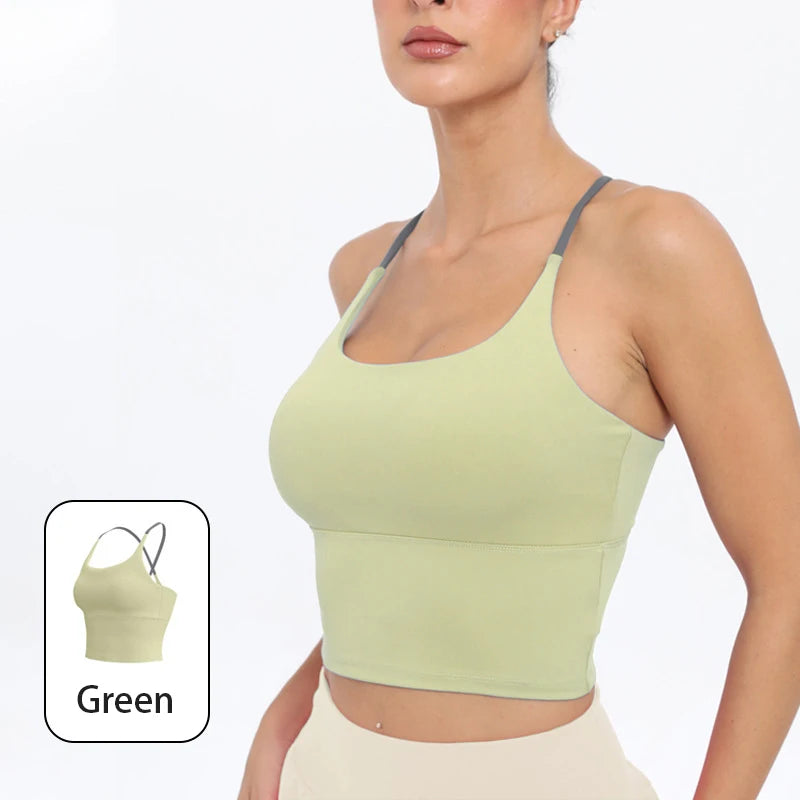 A model wearing a light green summer strappy yoga sports bra with built-in padding.