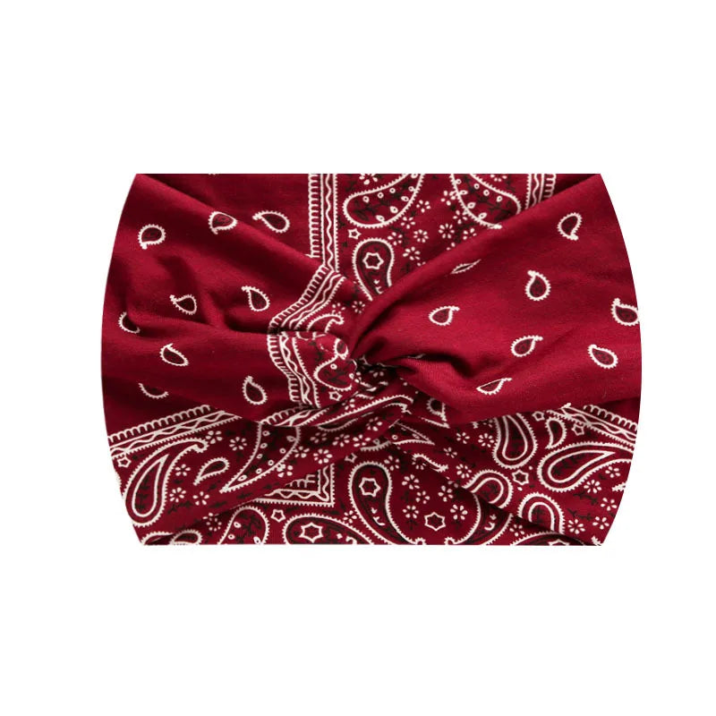 A deep red boho printed wide knotted headband with intricate white patterns.