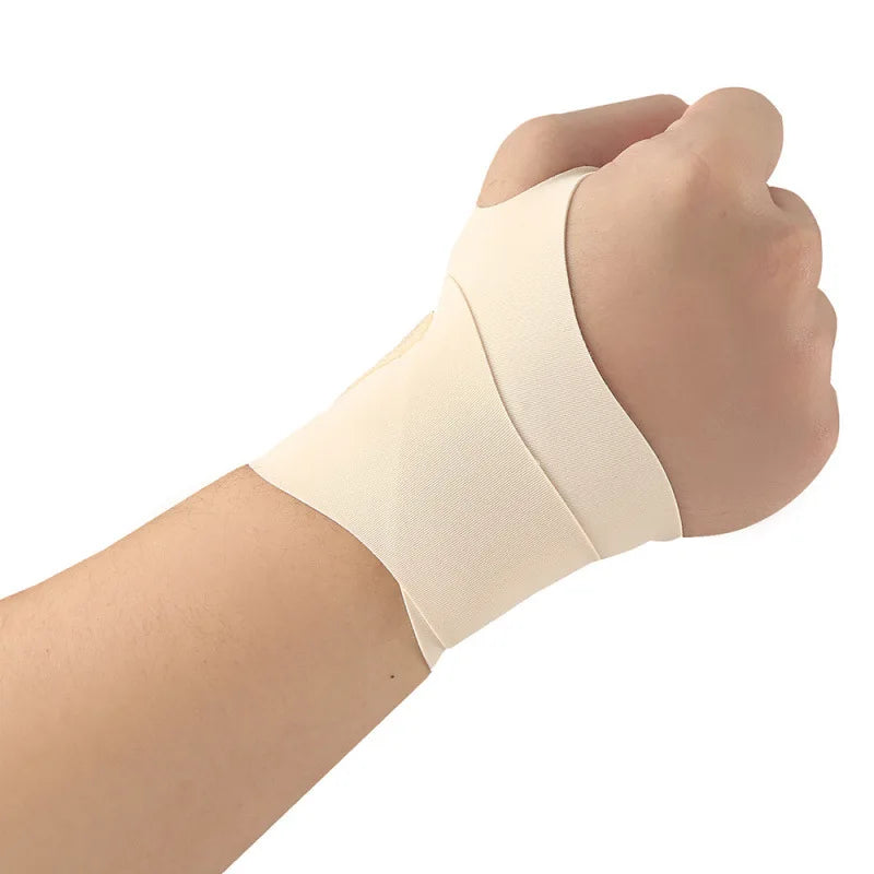 A hand is wearing a beige breathable wrist guard for sports and fitness.