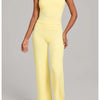 A woman models a yellow high-waist yoga and fitness tracksuit set top and pants.