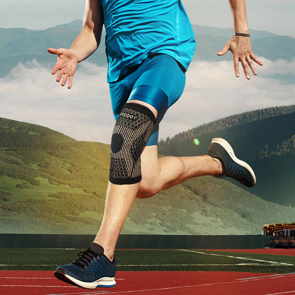 A person wearing a blue athletic outfit and black copper ion knee support sleeve is running outdoors.