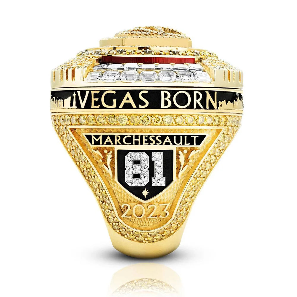 A close-up of a gold championship ring featuring the text VEGAS BORN MARCHESSAULT 81 and the year 2023.