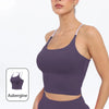 A model wearing a purple summer strappy yoga sports bra top and matching bottoms.