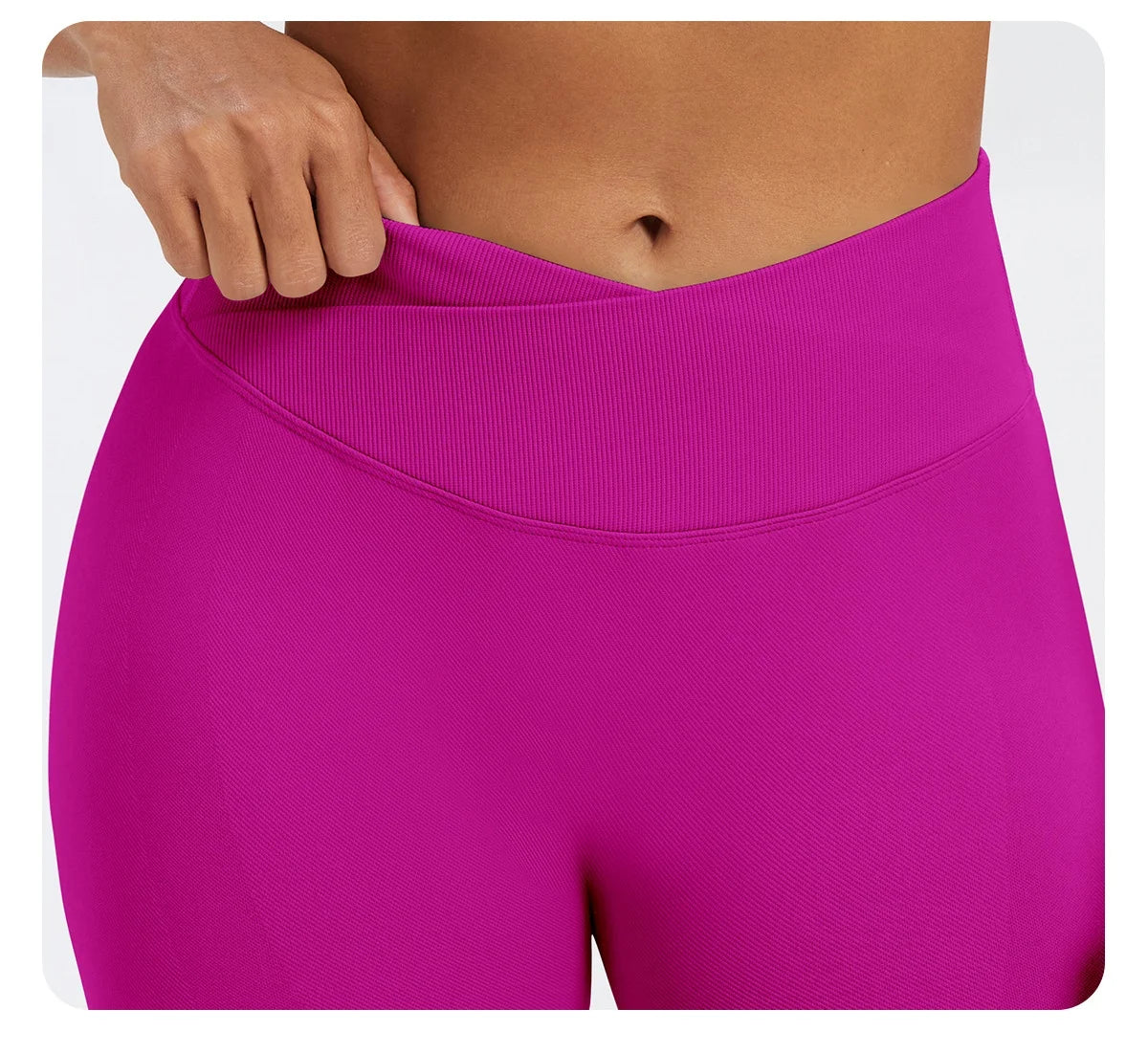 A close-up of a bright magenta seamless high-waist yoga legging worn by a person.