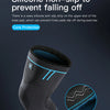 A black compression knee support sleeve with a blue non-slip silicone strip on the upper end.
