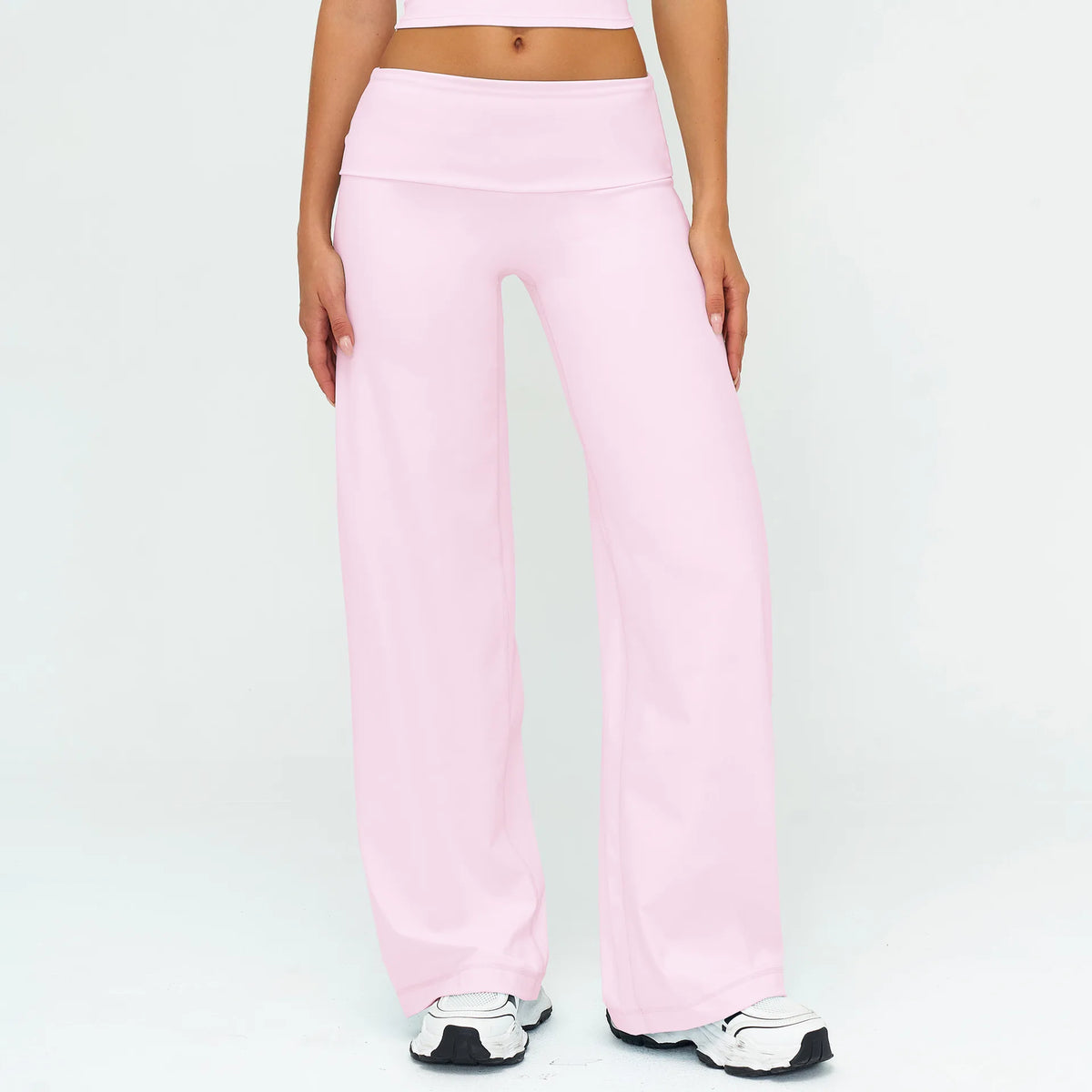 Light pink flared high-waist yoga pants worn by a person.