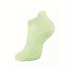 A light green grip pilates sock shown from the side.