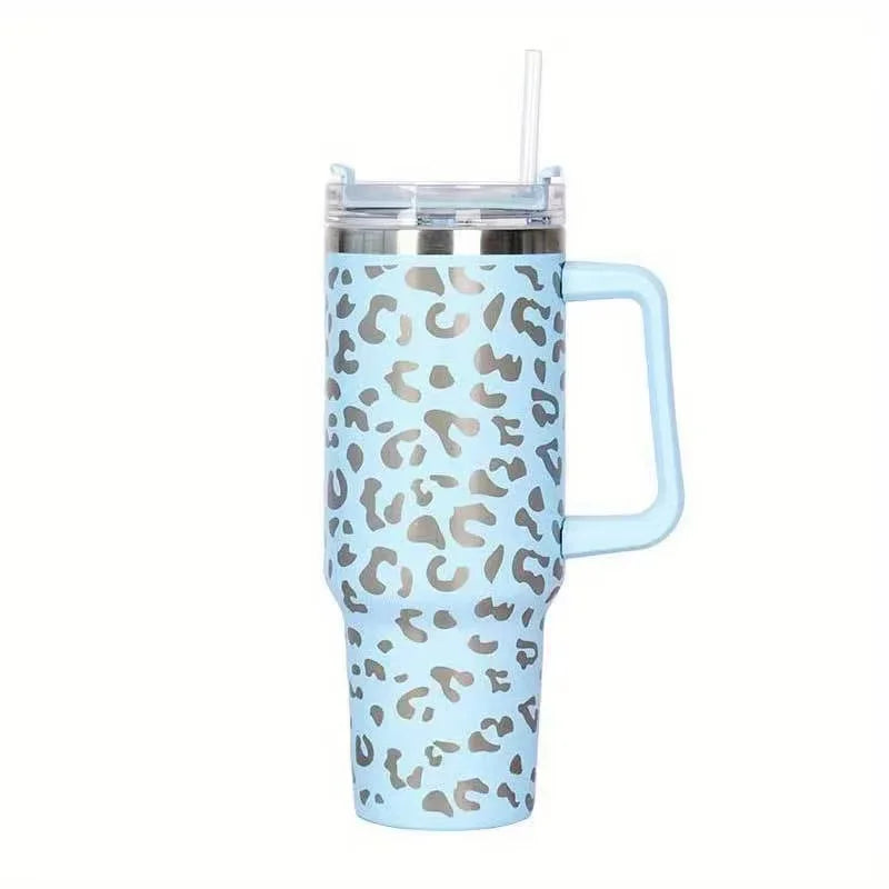 Tasse isotherme en acier inoxydable bleu clair avec motif léopard et paille transparente.