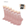 Six pairs of pink grip socks with white stripes shown next to a hand wearing one pair.