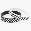 A black and white checkered silicone wristband shown against a white background.