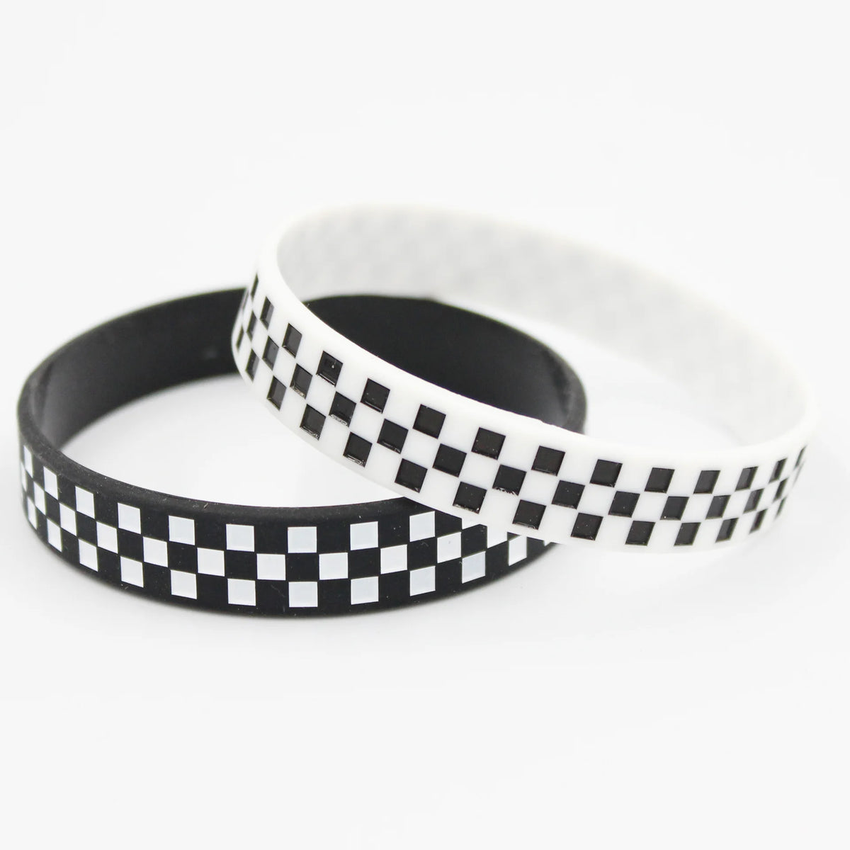 A black and white checkered silicone wristband shown against a white background.