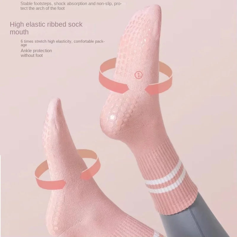 A close-up of a pink elastic ribbed sock worn on a foot, showing ankle protection and non-slip features.