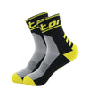 A pair of black and yellow performance cycling and running socks shown from the side.