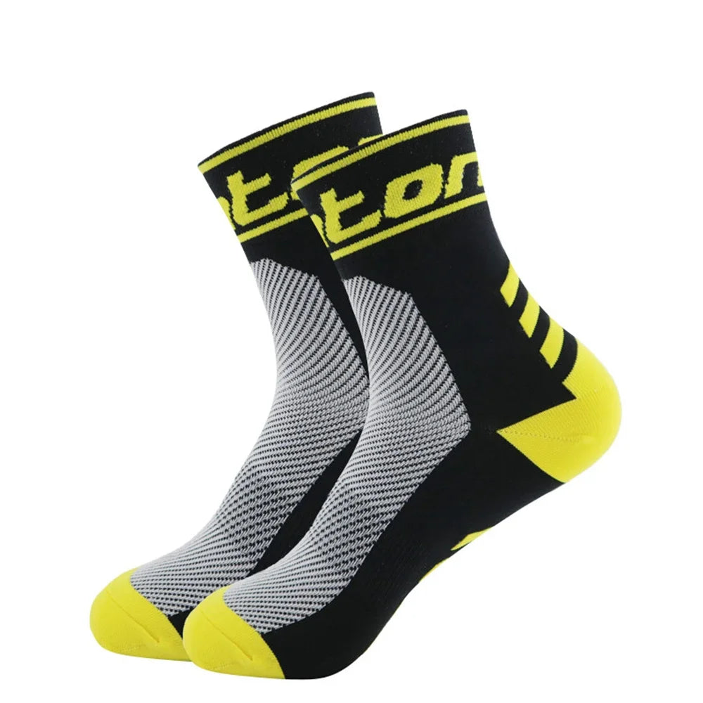 A pair of black and yellow performance cycling and running socks shown from the side.