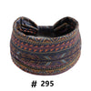 A dark patterned boho cotton turban headband with a bow, suitable for workout or yoga.