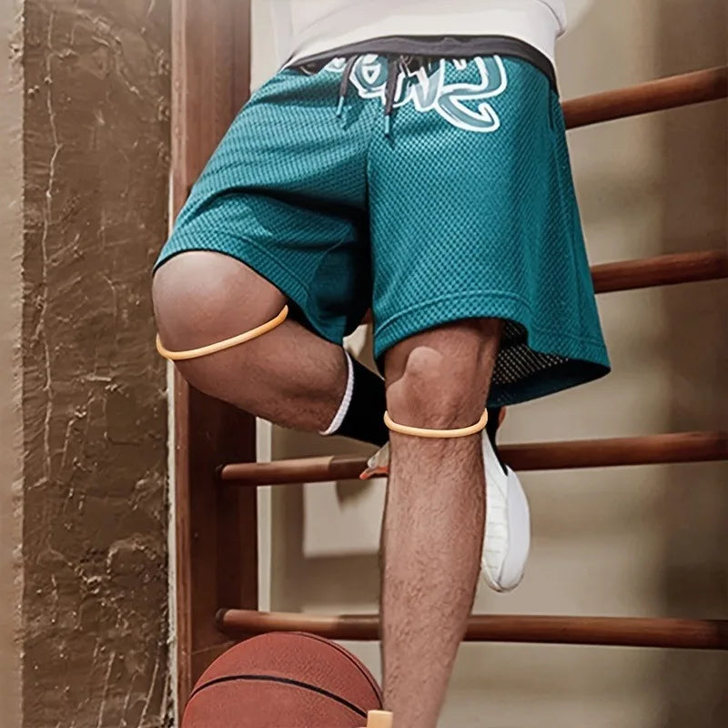 A person wearing teal athletic shorts and a white shirt is using a knee brace strap while standing on a wooden railing.