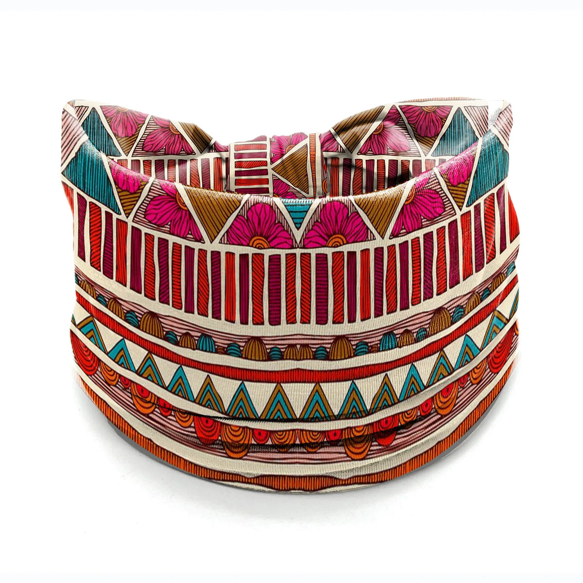 A close-up of a bohemian stretch cotton headband featuring geometric patterns in pink, teal, and red stripes.