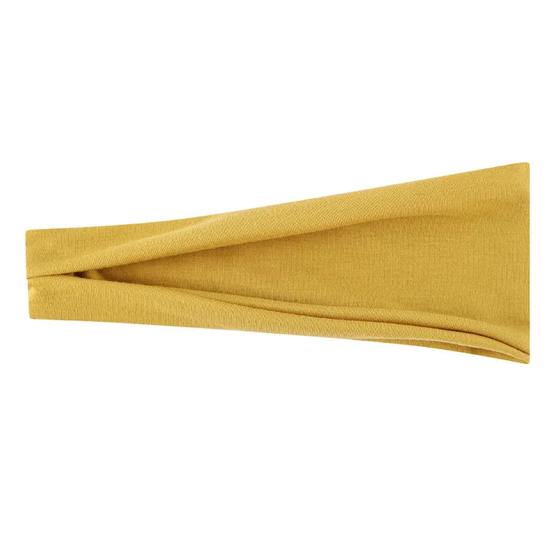 Tire-bande élastique jaune moutarde plié pour les cheveux ou le maquillage.