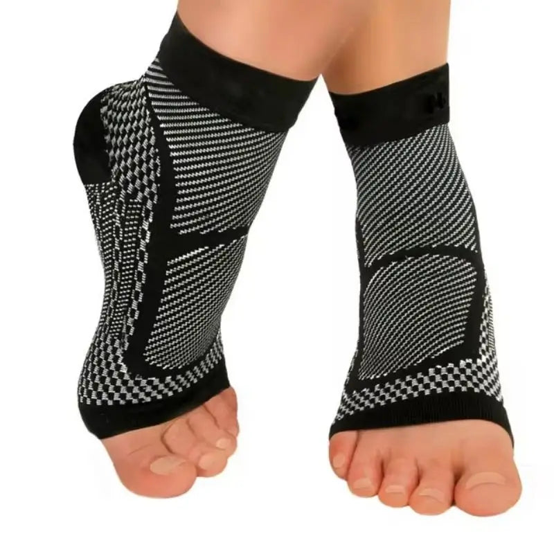 Black therapeutic compression socks worn on a foot and ankle.