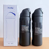 A black stainless steel vacuum insulated water bottle with a straw is shown next to its packaging.