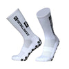 A pair of white football socks with black anti-slip silicone grips on the sole.
