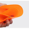 A hand holds an orange soccer training disc cones set.
