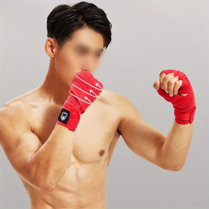 A male model wearing red professional cotton boxing hand wraps on his forearm, demonstrating a boxing stance.