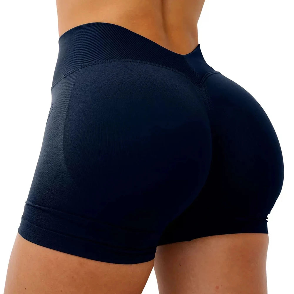 Dark navy seamless yoga shorts worn by a woman, showing the fit and texture.