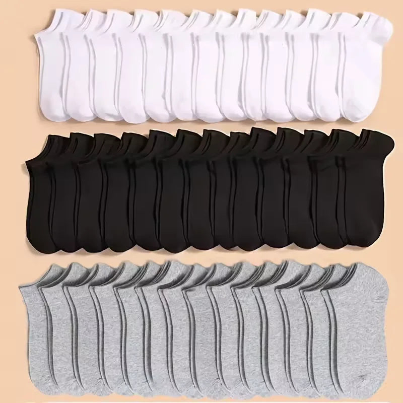 A collection of white, black, and gray soft lightweight ankle socks laid out in rows.
