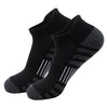 A pair of black athletic running socks with light gray stripes on the foot.