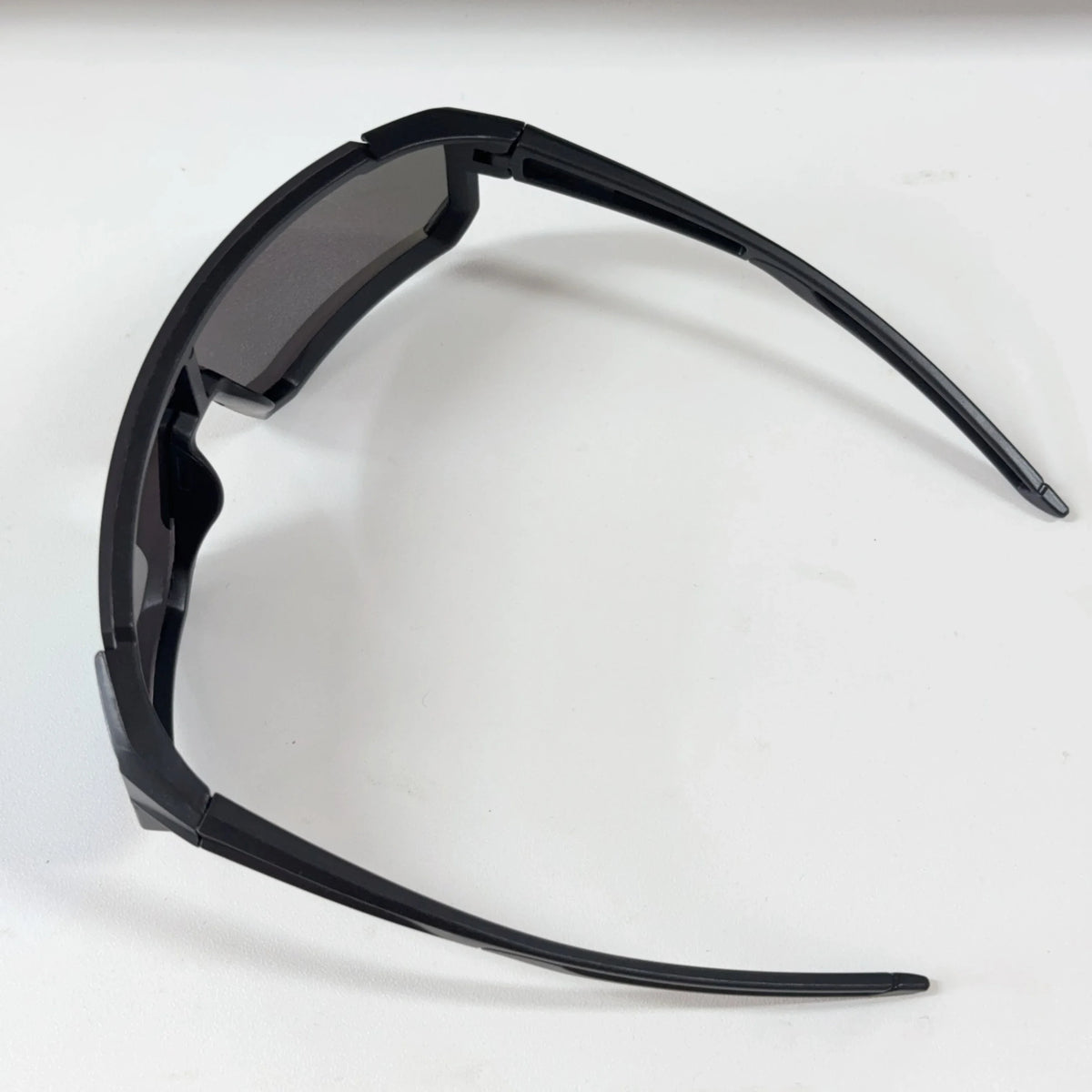 Black sports sunglasses with protective frames shown against a white background.
