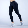 Une personne portant des leggings de yoga noirs à taille haute et des chaussures de sport blanches.
