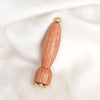 A wooden massage stick with brass lotus eyes, shown against a white background.