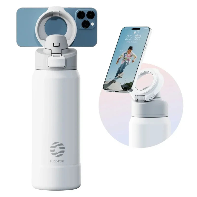 A white insulated sports water bottle with a magnetic lid is shown next to a smartphone.