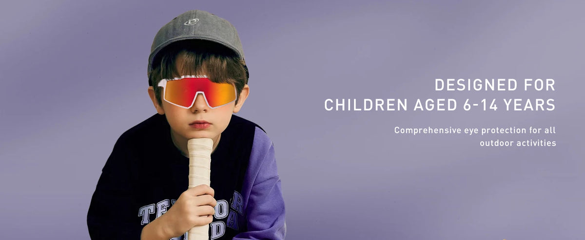 A child wearing orange polarized sports sunglasses and a grey cap is shown against a purple background.