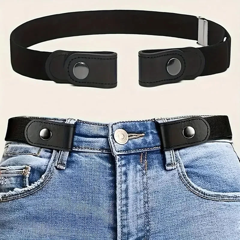 Black invisible stretch elastic belt with silver buckle shown alongside a pair of blue denim jeans.