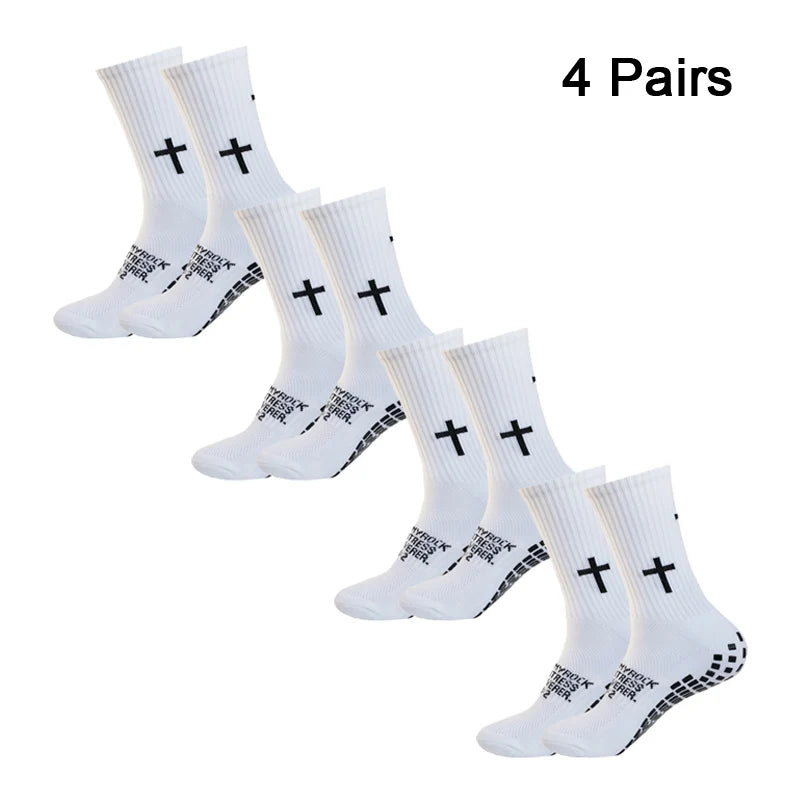 Four pairs of white athletic socks with black cross patterns displayed on a white background.