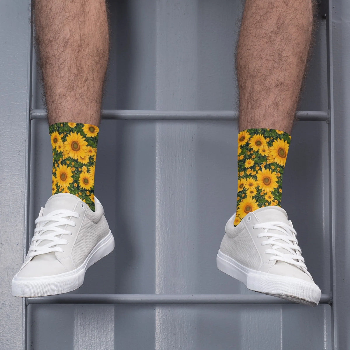 A pair of white sneakers worn with yellow sunflower print breathable crew socks against a gray background.