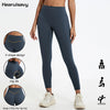 A model wearing dark blue V-shape high-waist yoga leggings demonstrating hip lift features.