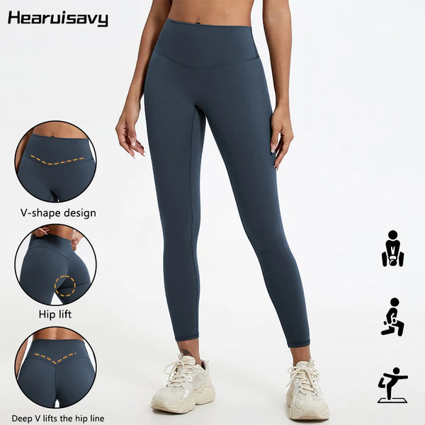 A model wearing dark blue V-shape high-waist yoga leggings demonstrating hip lift features.