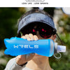 A person holds a bright blue WRELS soft water bottle outdoors while wearing a dark cap and sunglasses.