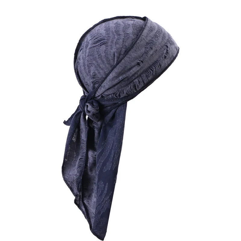 A dark blue distressed pirate style durag head wrap folded and displayed.