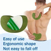 A hand is applying a green ergonomic heat patch to the back of a person's neck and shoulder area.