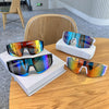 A display of UV400 cycling sunglasses in various colors resting on a wooden table.