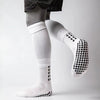 White athletic grip socks with black patterned toes and cuff, worn by a person.