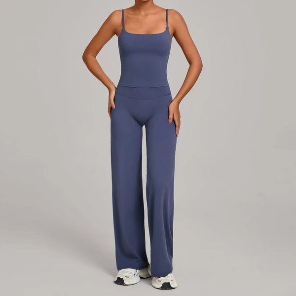 A woman wearing a navy blue high-waist yoga and fitness tracksuit set.