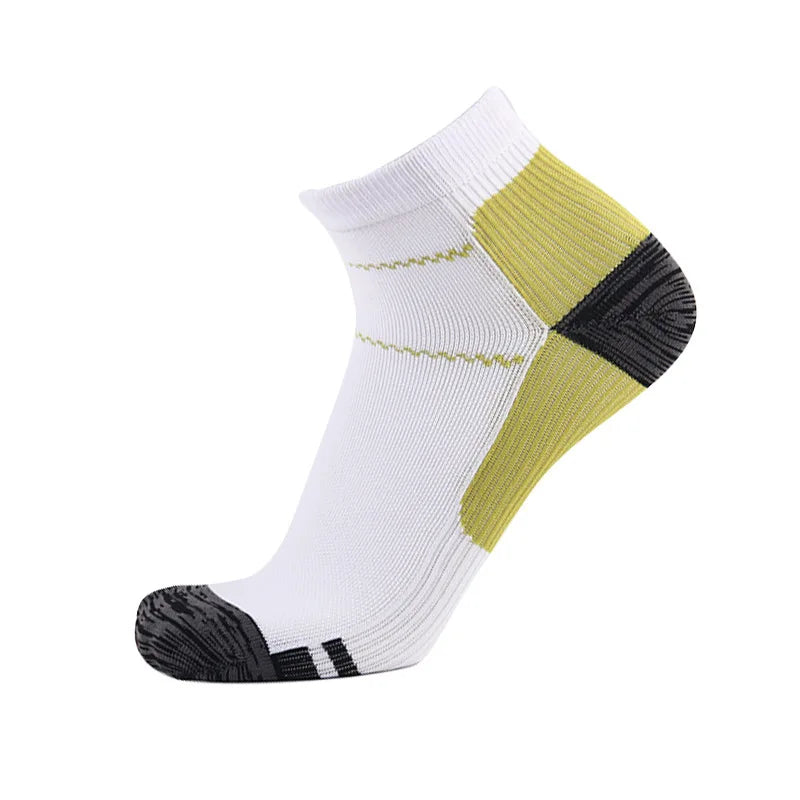 A pair of white compression socks with yellow and black accents, shown from the side.