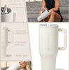 A white insulated stainless steel water bottle with a handle and flip straw shown in various contexts.