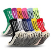 A variety of brightly colored performance sports grip socks displayed in a row.
